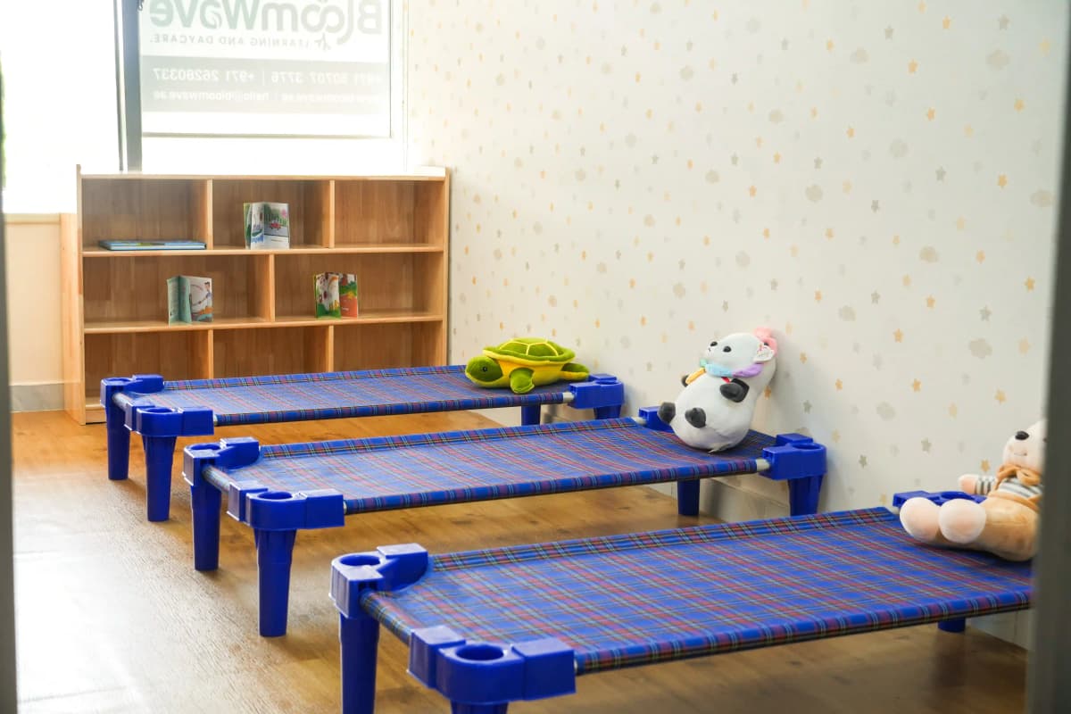 Comfortable rest area with child-sized beds at BloomWave daycare